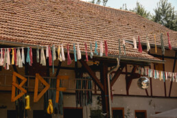 Ein Hof mit Fachwerkhäusern und bunten Fähnchen